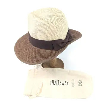 Beige straw hat with brown band and bow on a mannequin head, with 'THATaway' packaging below.