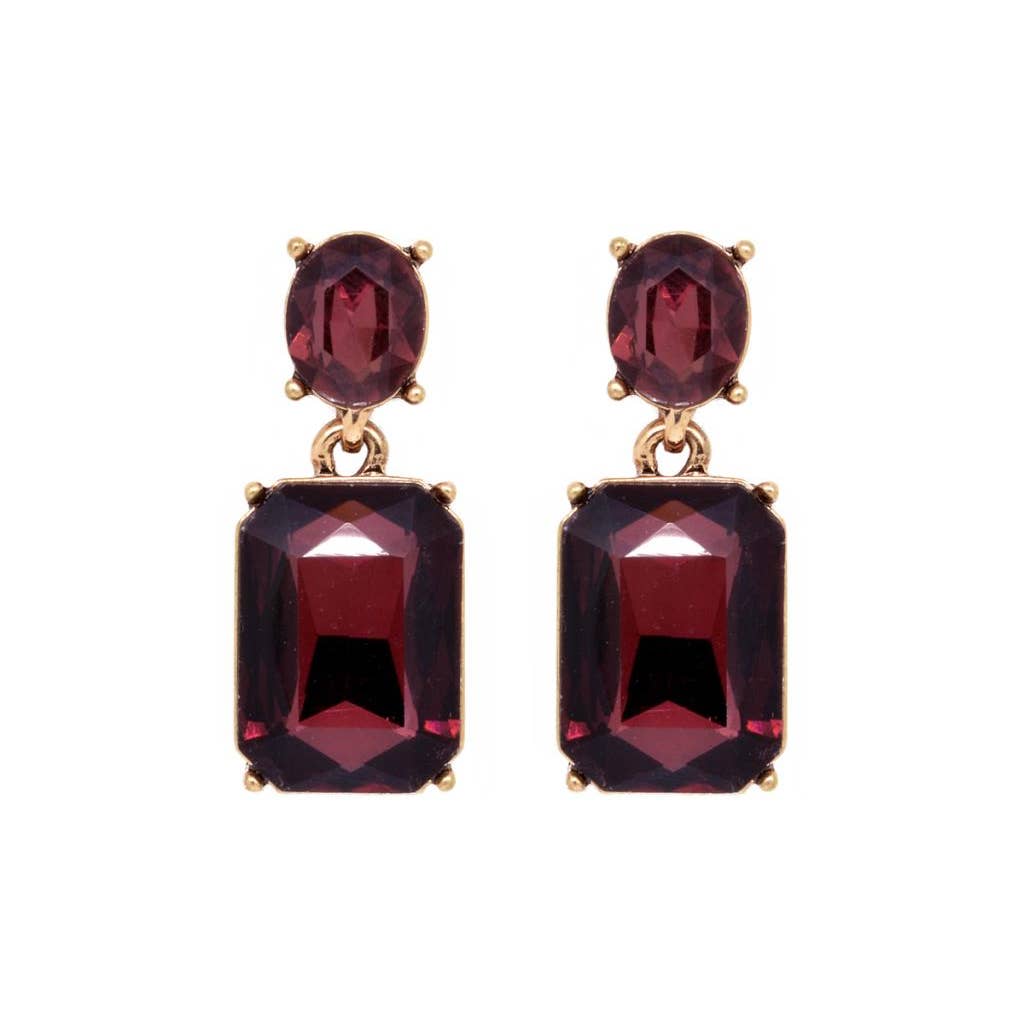 Pair of earrings with red gemstones on a white background