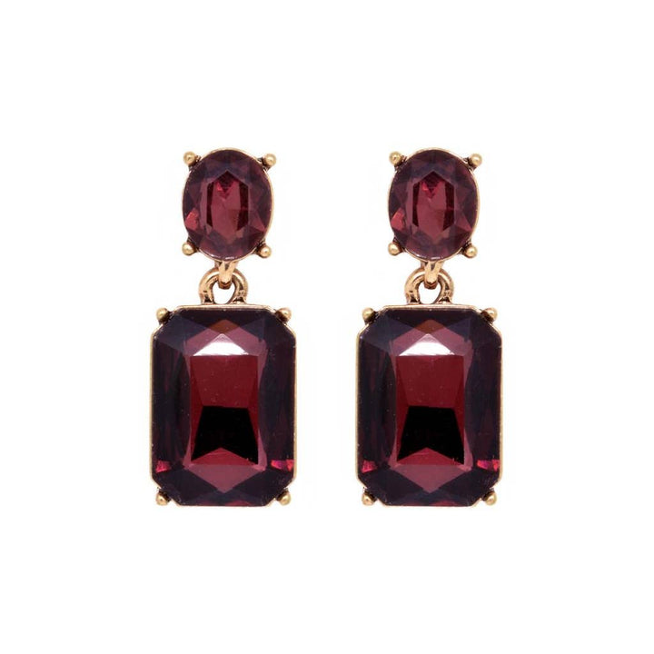 Pair of earrings with red gemstones on a white background