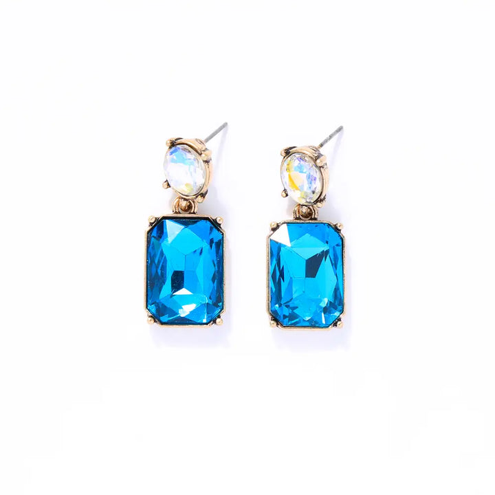 Pair of earrings with blue gemstones on a white background