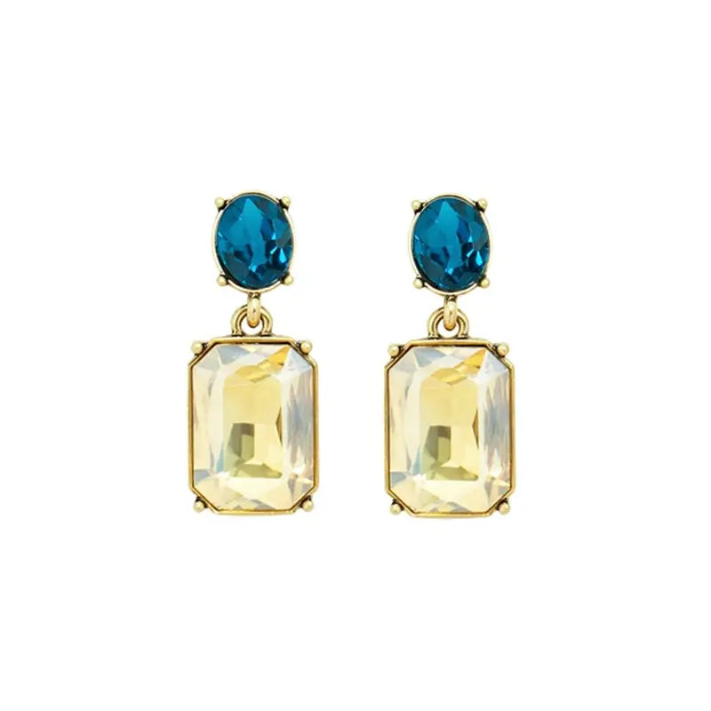 A pair of gold-tone drop earrings featuring an oval teal blue gemstone above a larger rectangular pale yellow crystal, shown on a plain white background.