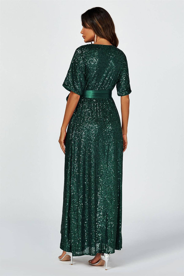 Woman wearing a green sequin dress on a white background