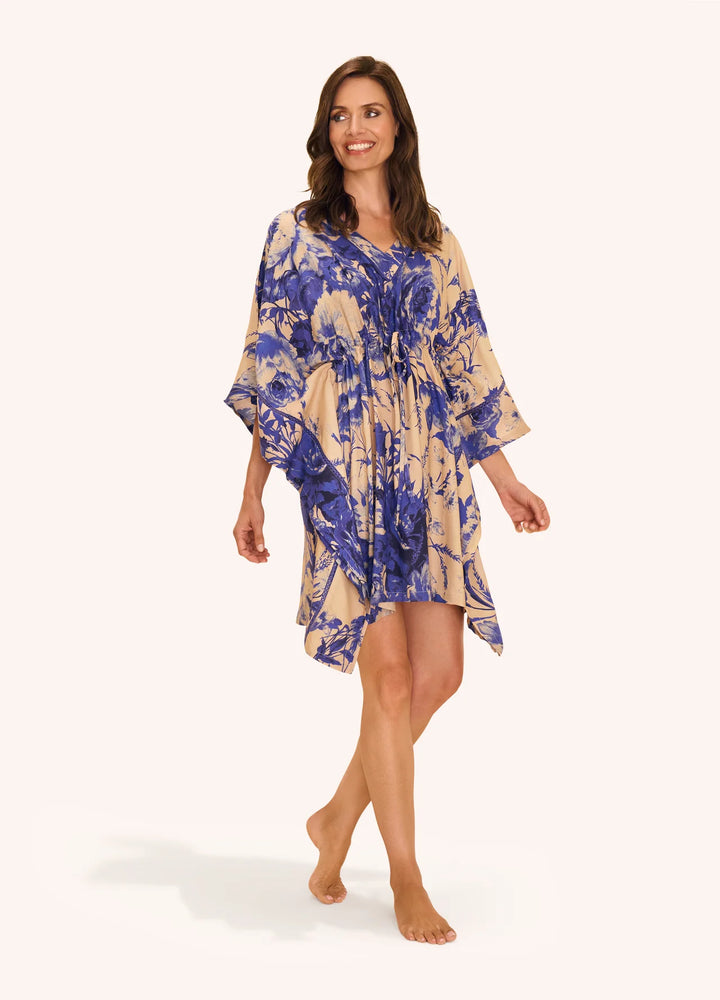 Woman wearing a blue and beige patterned dress on a white background