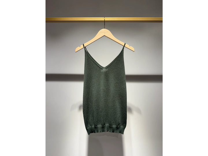 Green tank top on a hanger against a gray background