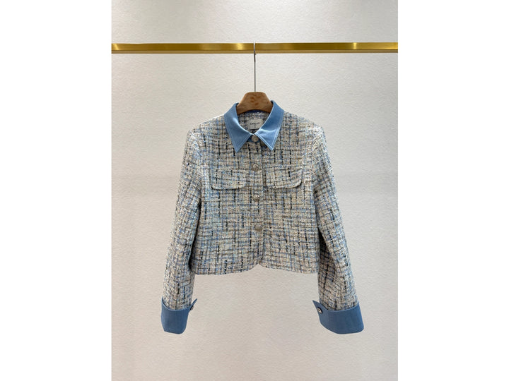 Plaid jacket with blue collar and cuffs on a white background