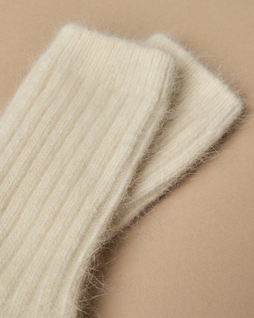 Close-up of beige knitted fabric on a beige background