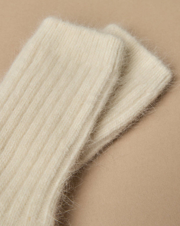 Close-up of beige knitted fabric on a beige background
