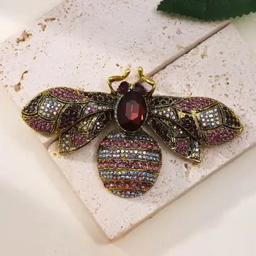 Decorative brooch with gemstones on a textured surface