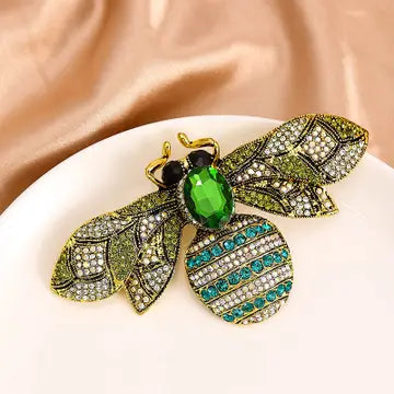 Decorative brooch with gemstones on a beige fabric background