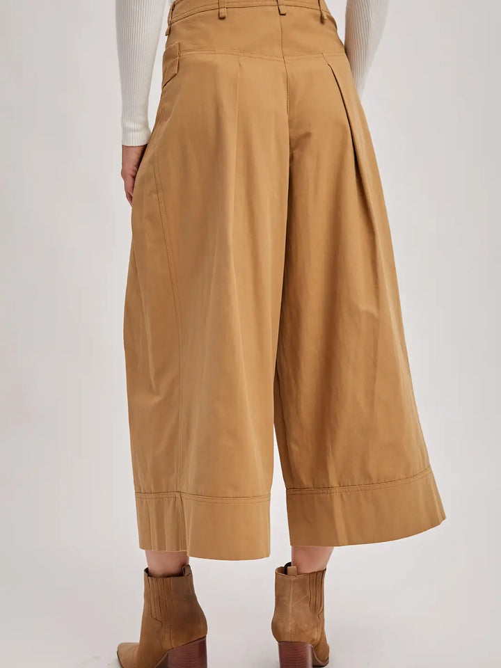 Tan wide-leg pants worn by a person on a white background