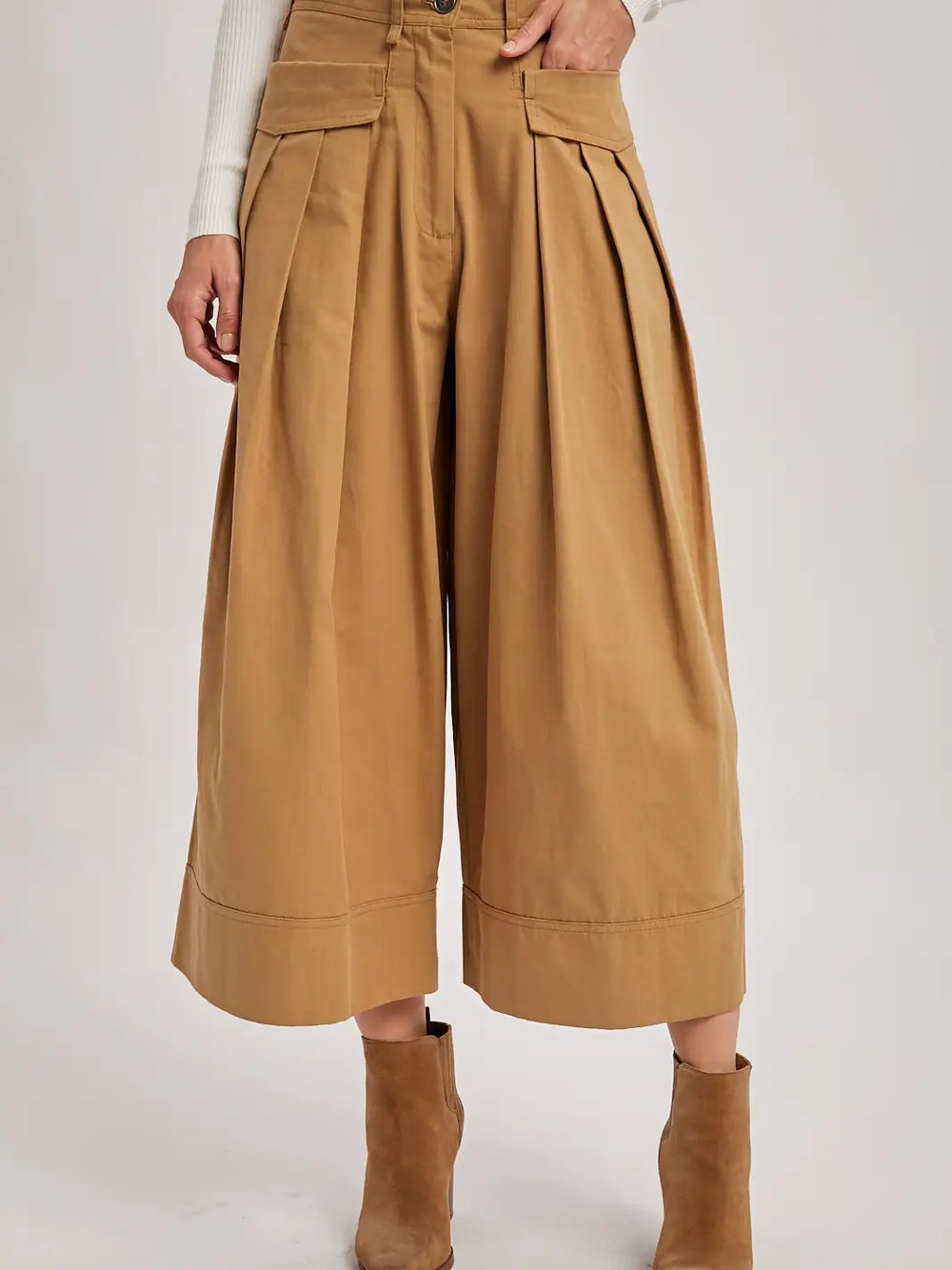 Tan wide-leg pants worn by a person on a white background