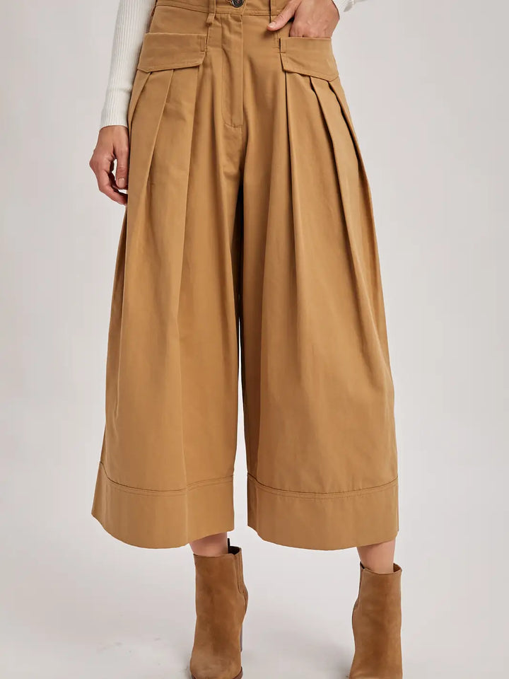 Tan wide-leg pants worn by a person on a white background