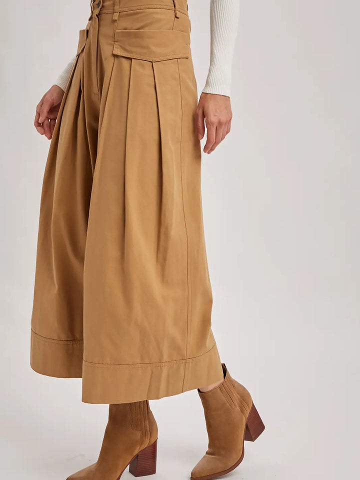 Tan skirt worn by a person on a white background