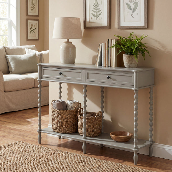 Gray console table in a living room with decor items