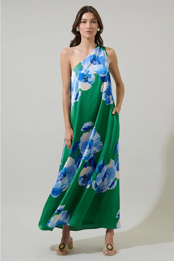 Woman wearing a green floral dress against a plain background