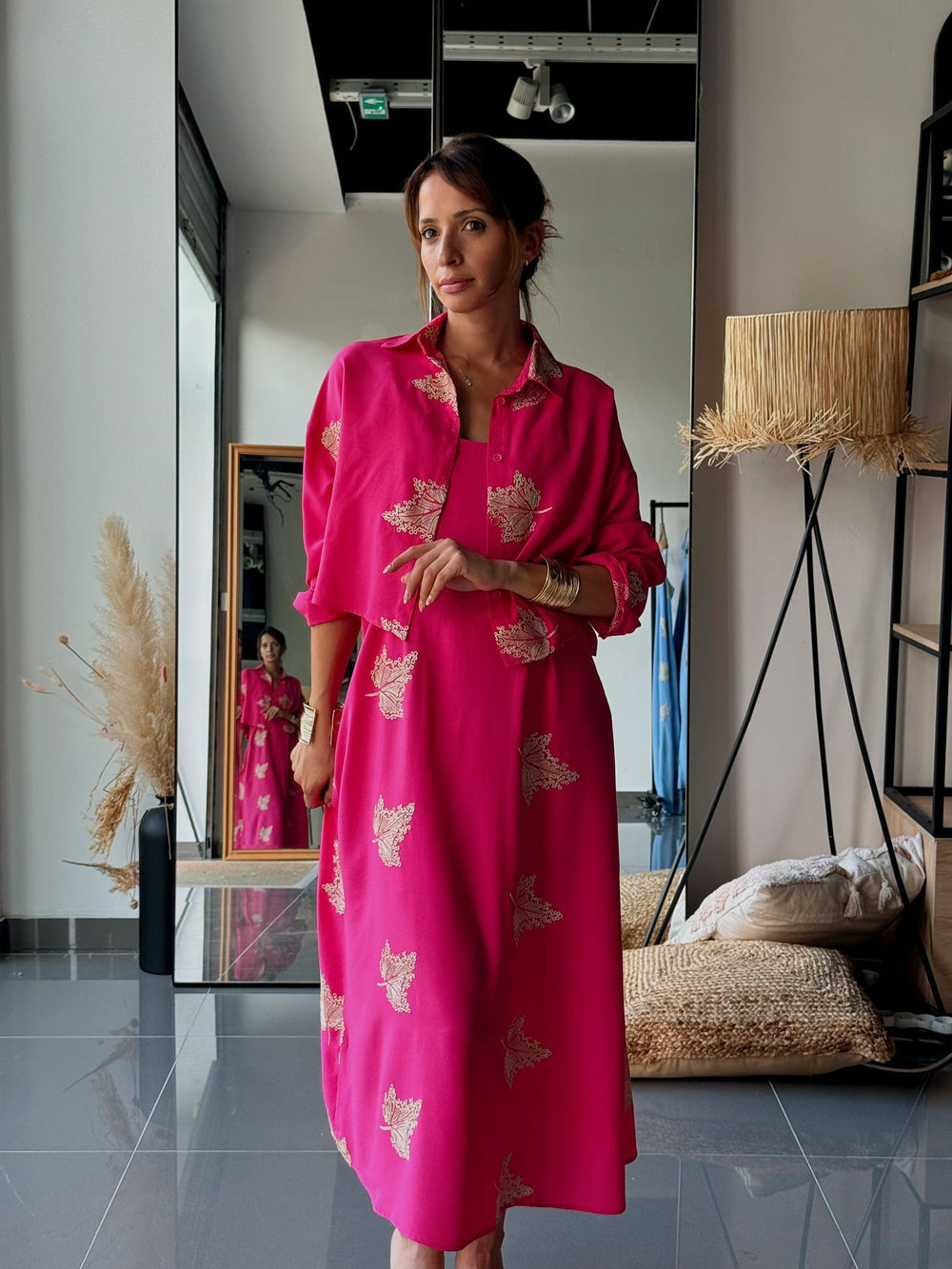 Woman in a pink dress standing in a modern interior setting