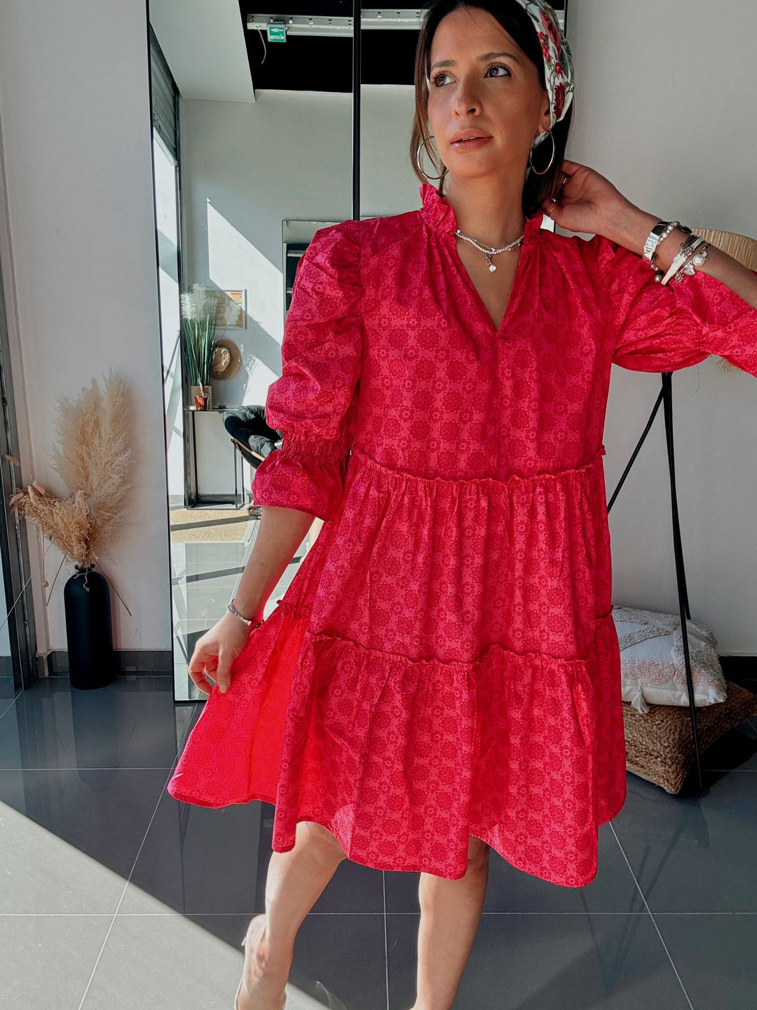 Woman wearing a red dress in an indoor setting