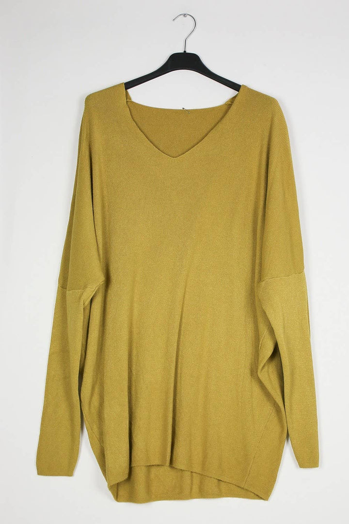 Mustard yellow sweater on a hanger against a white background