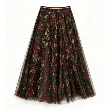 A pleated tulle midi skirt with a dark floral print featuring red and pink flowers and green leaves on a sheer black mesh background, shown against a plain white background.
