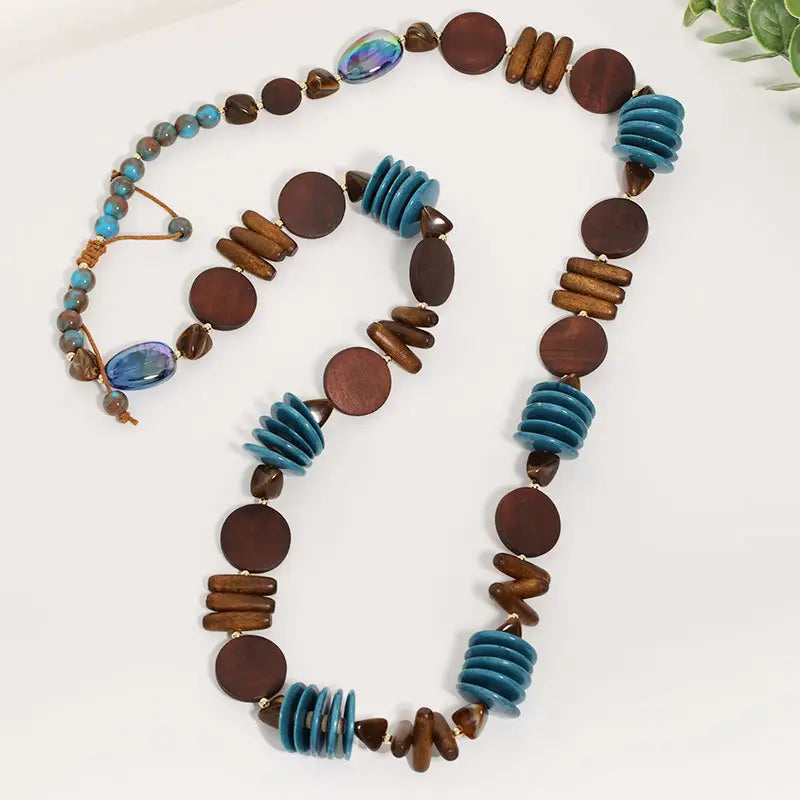 Necklace with brown and blue beads on a white background