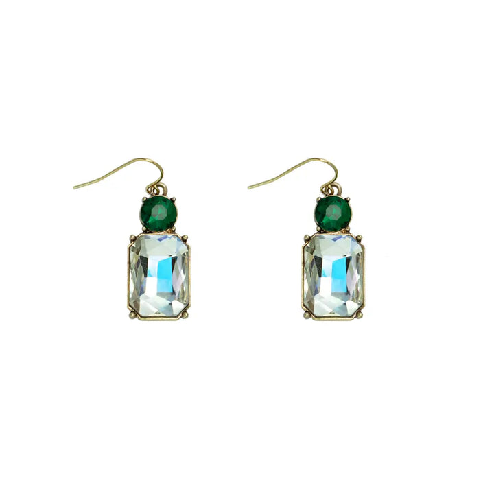 Pair of earrings with green gemstones and clear rectangular stones on a white background
