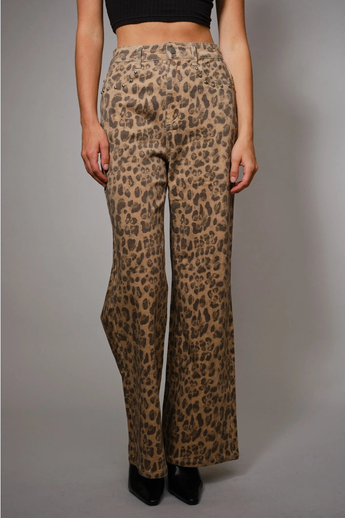Leopard print pants worn by a person on a gray background