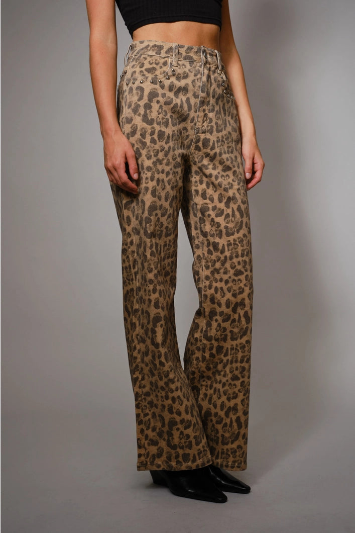 Leopard print pants worn by a person on a gray background