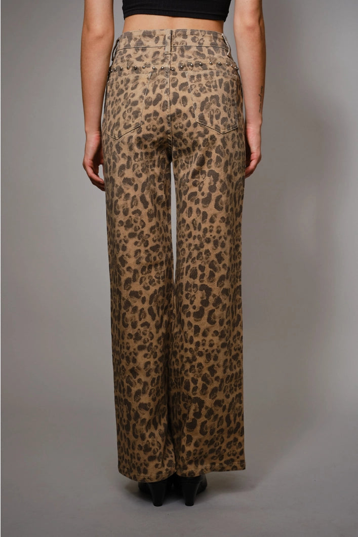 Leopard print pants worn by a person on a gray background